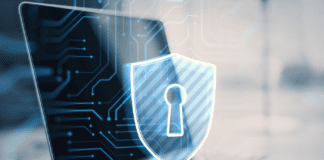 Blue shield icon with keyhole emblem within a circuit grind on a laptop background image.