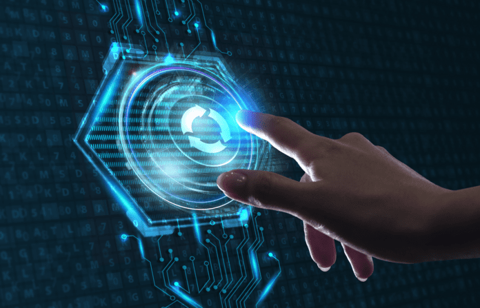 Hand interacting with a virtual update icon embedded on an integrated circuit.
