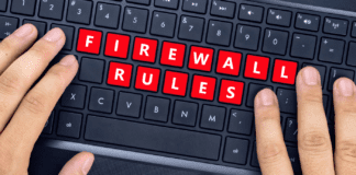 Person's hands on computer keyboard with keys reading "Firewall Rules."